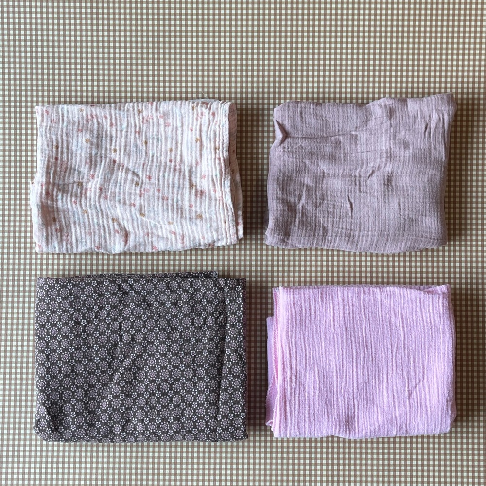 Set of 4 lightweight 100% cotton baby blankets.